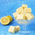 Lemon Fudge squares in a candy dish with real lemon in the background