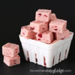 strawberry fudge in a white berry basket on a black background
