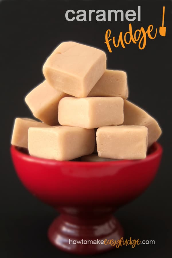 creamy salted caramel fudge piled high in a red candy dish on a black background