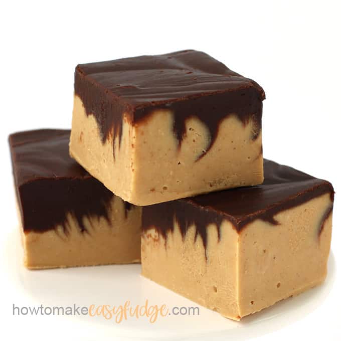3 pieces of chocolate peanut butter fudge stacked on a small white plate--easy fudge recipe 