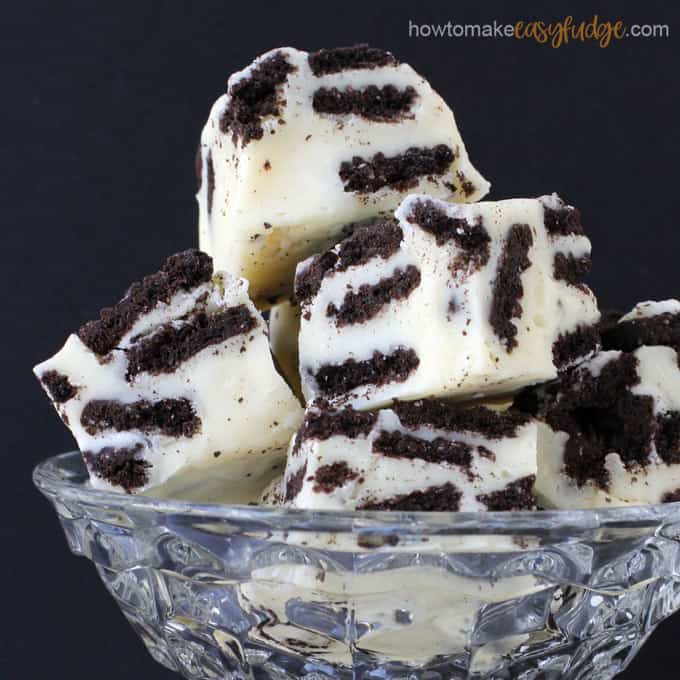 easy fudge recipe with squares of cookies and cream fudge filled with OREO Cookies are stacked up in a candy dish.