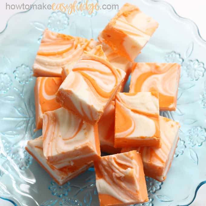 Orange creamsicle easy fudge recipe overhead image on blue plate