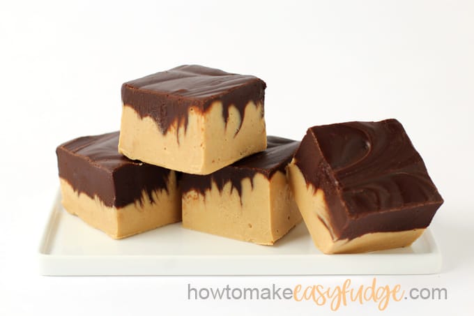 Squares of swirled peanut butter chocolate fudge staked on a long white plate with the watermark "how to make easy fudge"