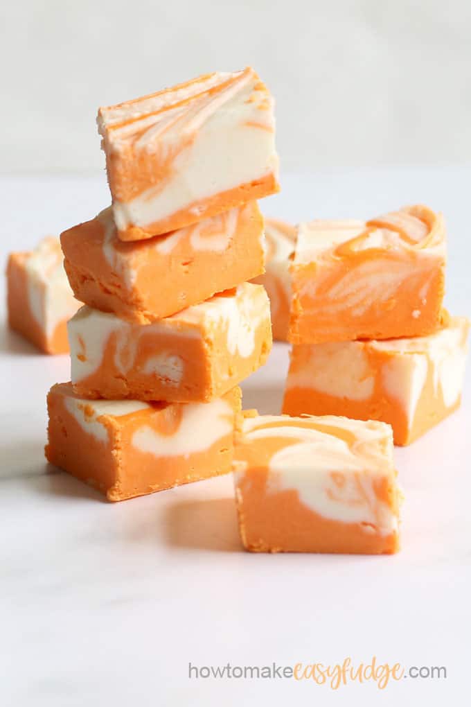 stack of easy orange creamsicle fudge with white background 