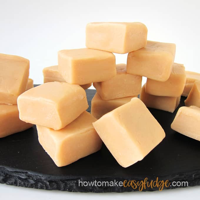 squares of soft caramel fudge on a black slate