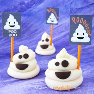 3 poop emoji fudge ghosts on a purple background each holding a poop emoji sign