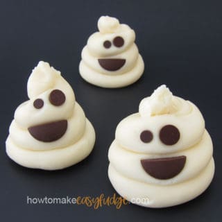 Cute little white chocolate fudge Poop Emoji Ghosts are sitting on a black background.