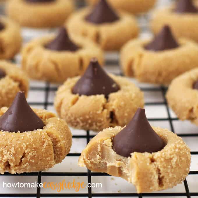 peanut blossom "cookie" fudge arranged on a cooling rack and the one in front has a bite taken out of it