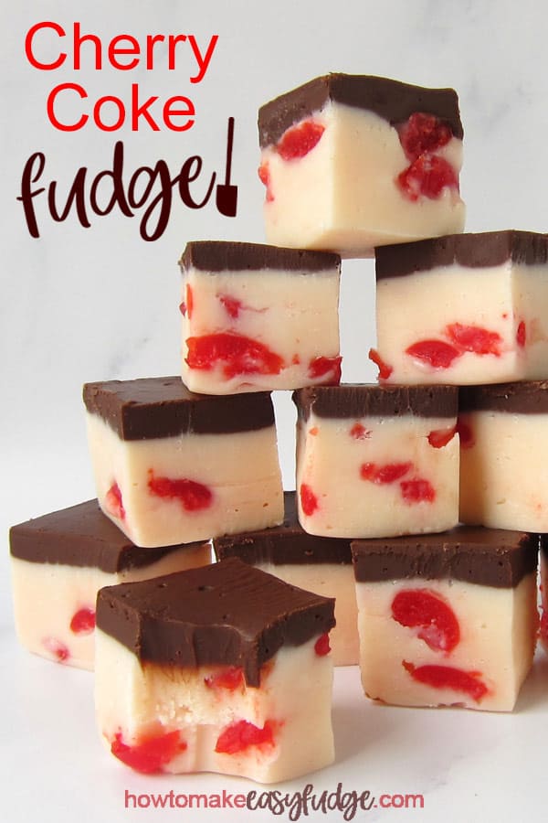 vertical image of squares of cherry coke fudge with layers of white chocolate cherry fudge topped with cola flavored chocolate fudge