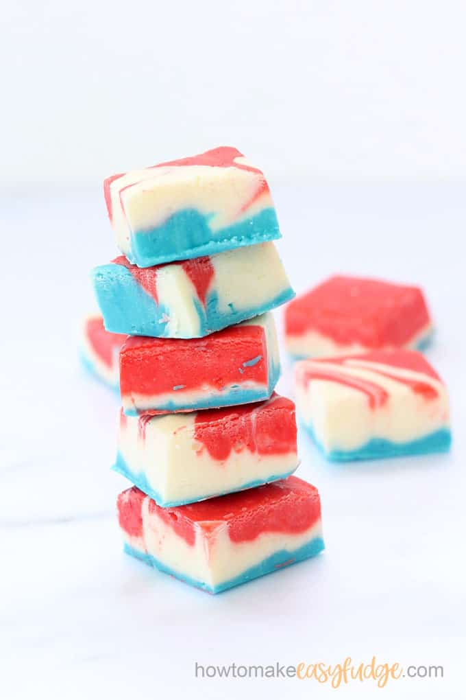 pieces of red white and blue fudge stacked with white background