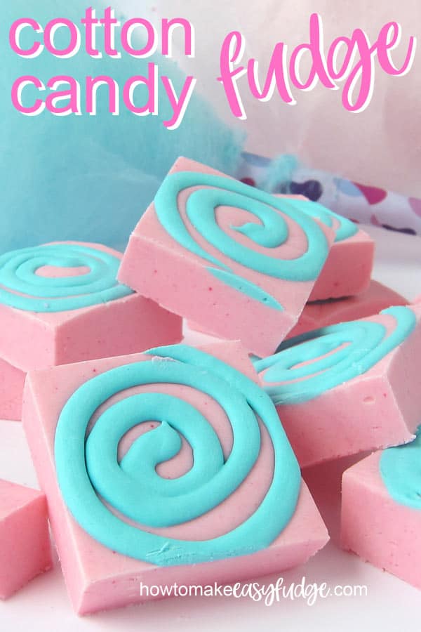 Squares of pink and blue swirled cotton candy fudge set in front of freshly made homemade cotton candy.