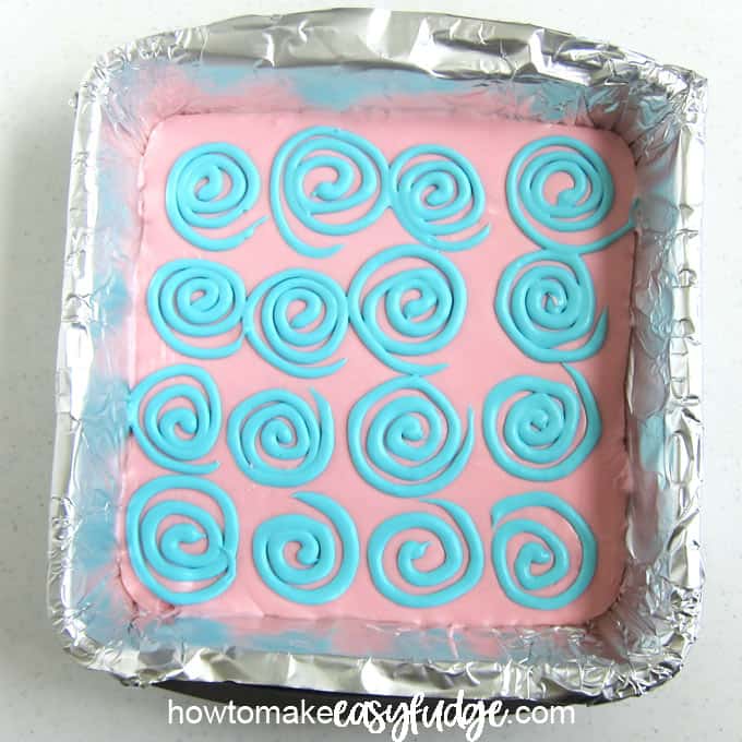 Pink fudge topped with blue swirls is flavored using cotton candy oil.