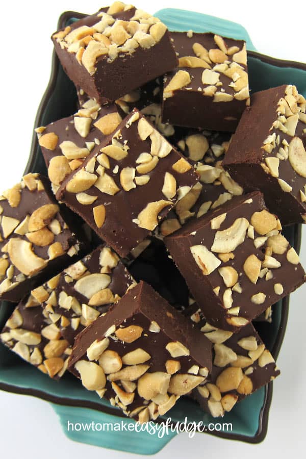 2-ingredient Chocolate Cashew Butter Fudge topped with chopped cashews is cut into squares. 