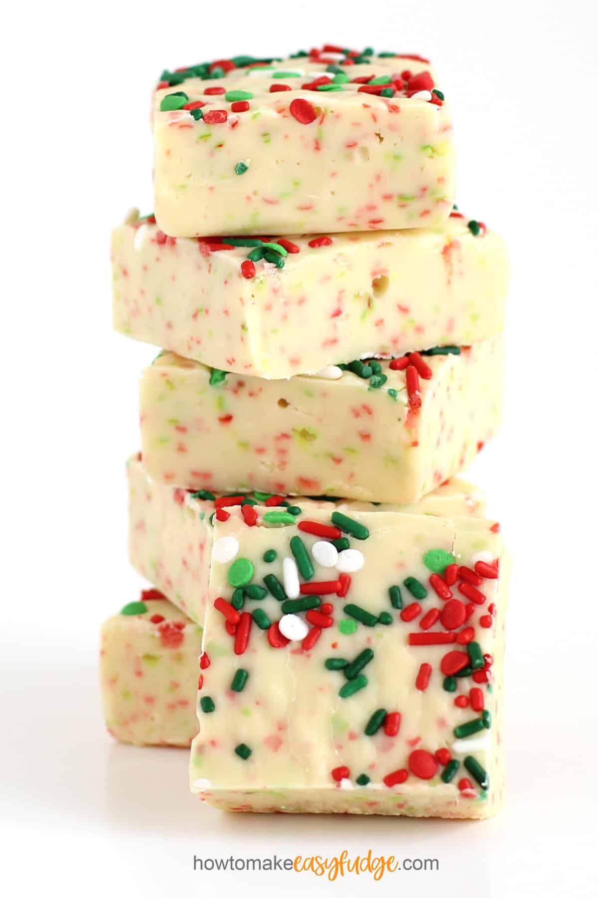 Easy sugar cookie fudge squares topped with red, green, and white Christmas sprinkles.