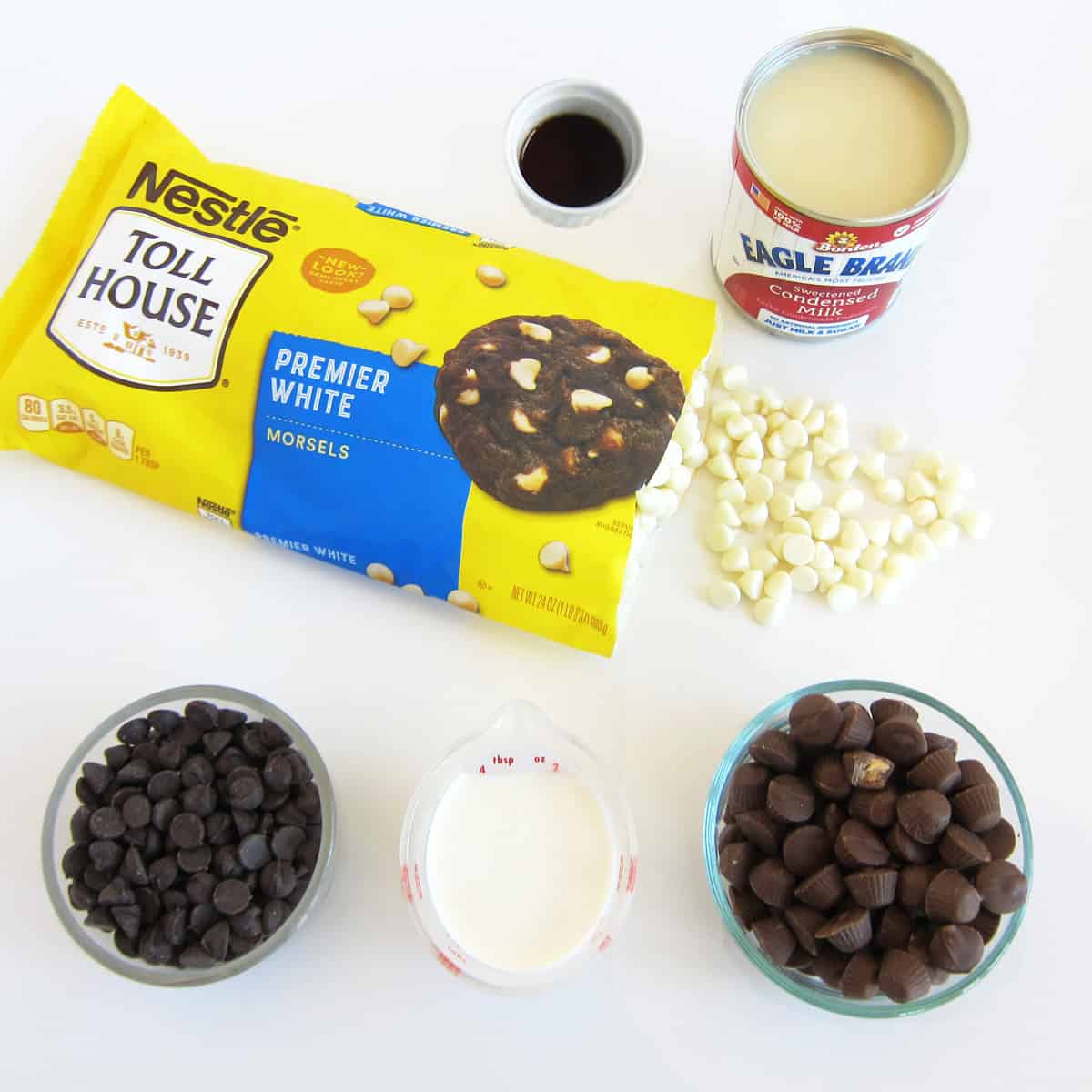 easy fudge recipe ingredients including white chocolate, sweetened condensed milk, vanilla, chocolate, and peanut butter chips