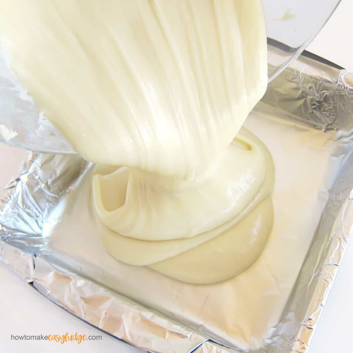 pour white chocolate fudge into a tin foil-lined baking pan