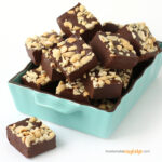 Cashew butter fudge piled in a teal-colored rectangle dish