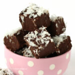 chocolate coconut fudge piled up in a pink polka dot bowl