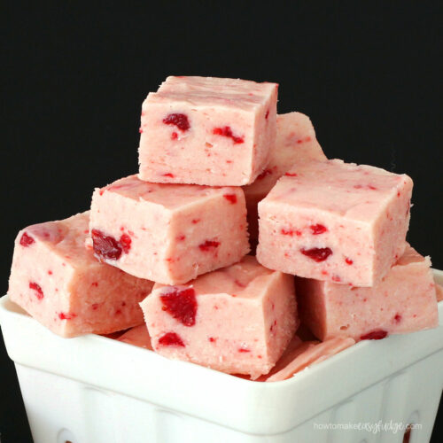 strawberry fudge stacked in a fruit basket on a black background