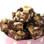 S'mores fudge filled with graham crackers and toasted marshmallows in a pink polka dot bowl