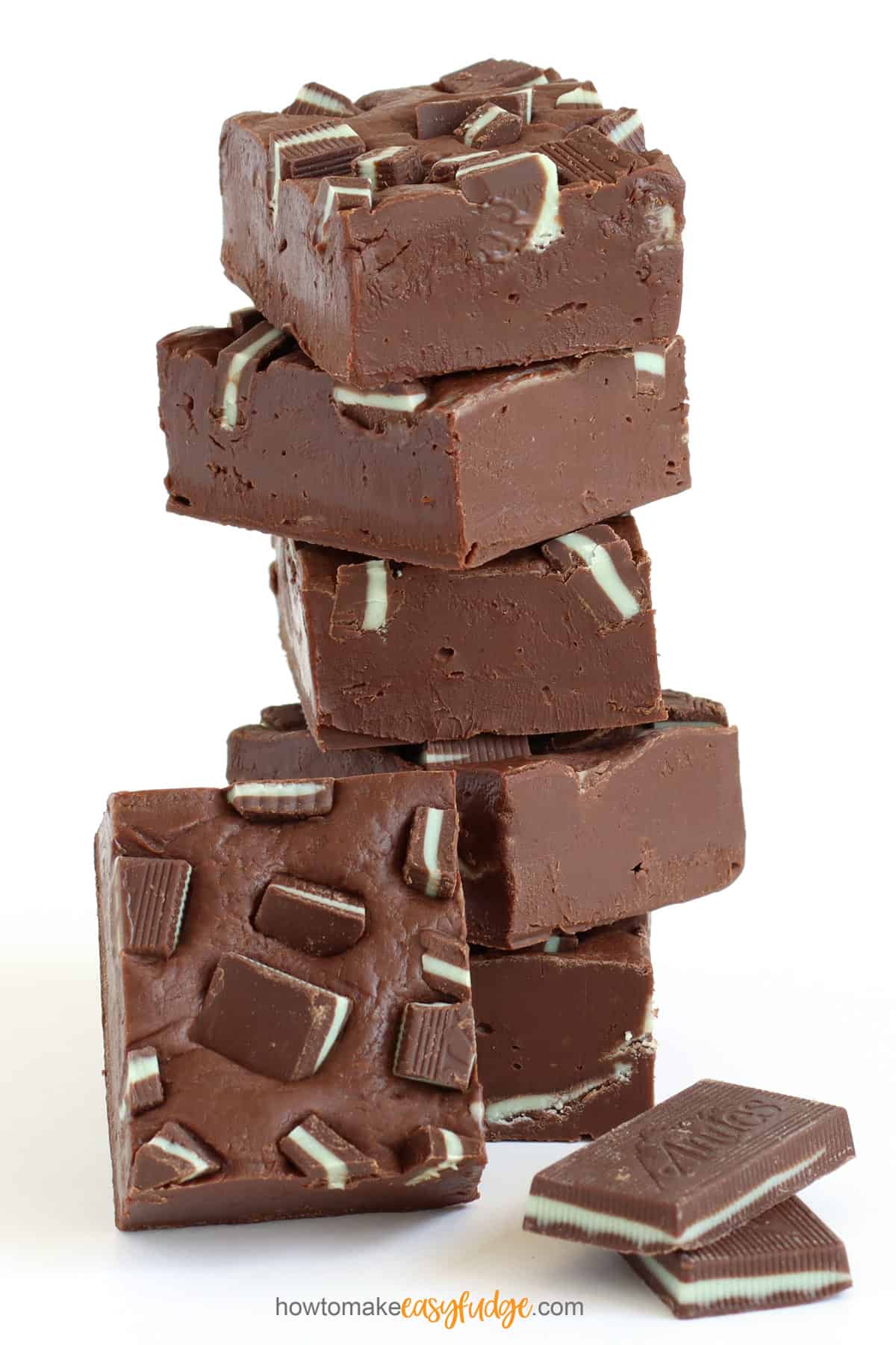 chocolate Andes Mint fudge stacked up next to two Andes Mints