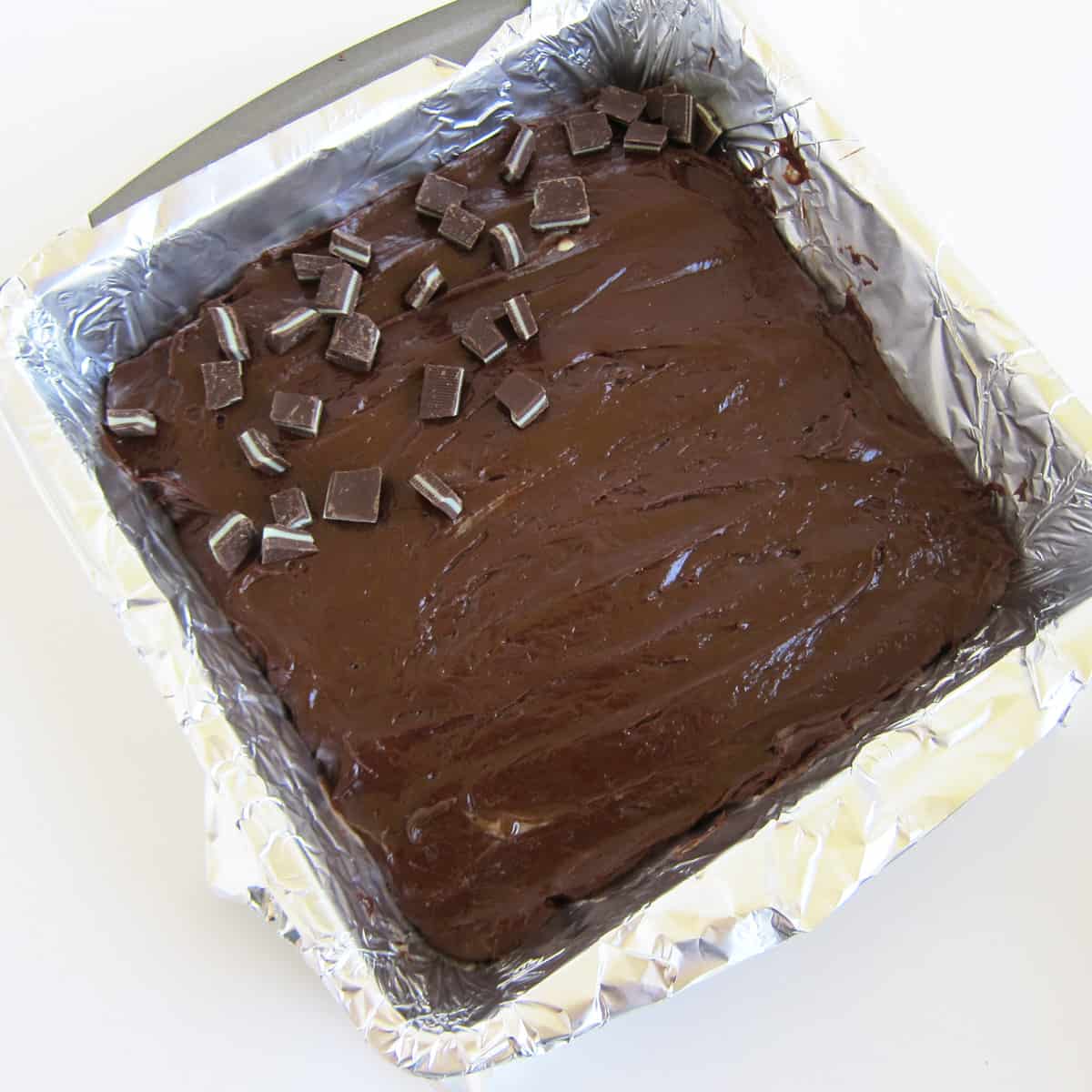 a pan of chocolate fudge topped with chopped A des Mints