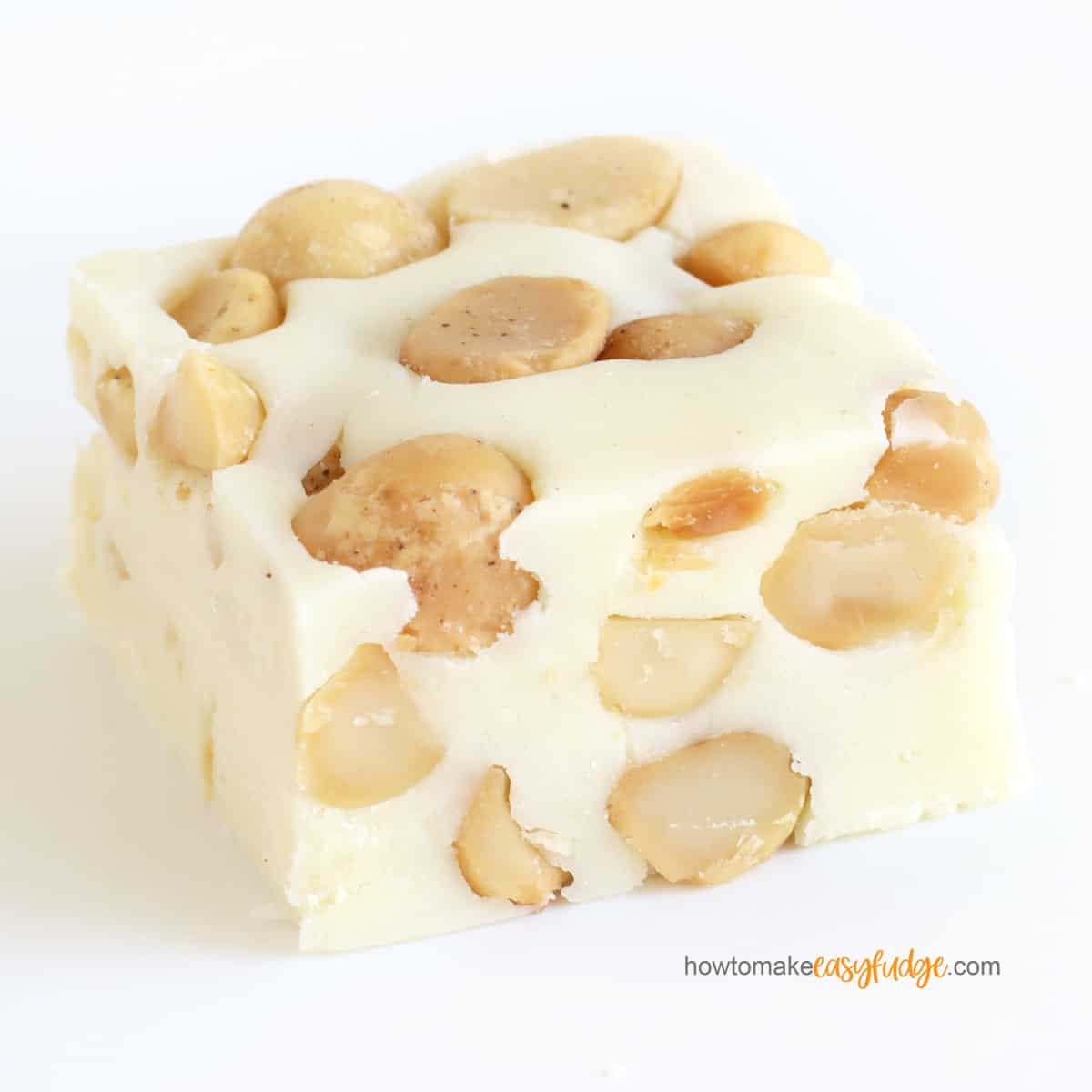 closeup of a square of white chocolate macadamia nut fudge