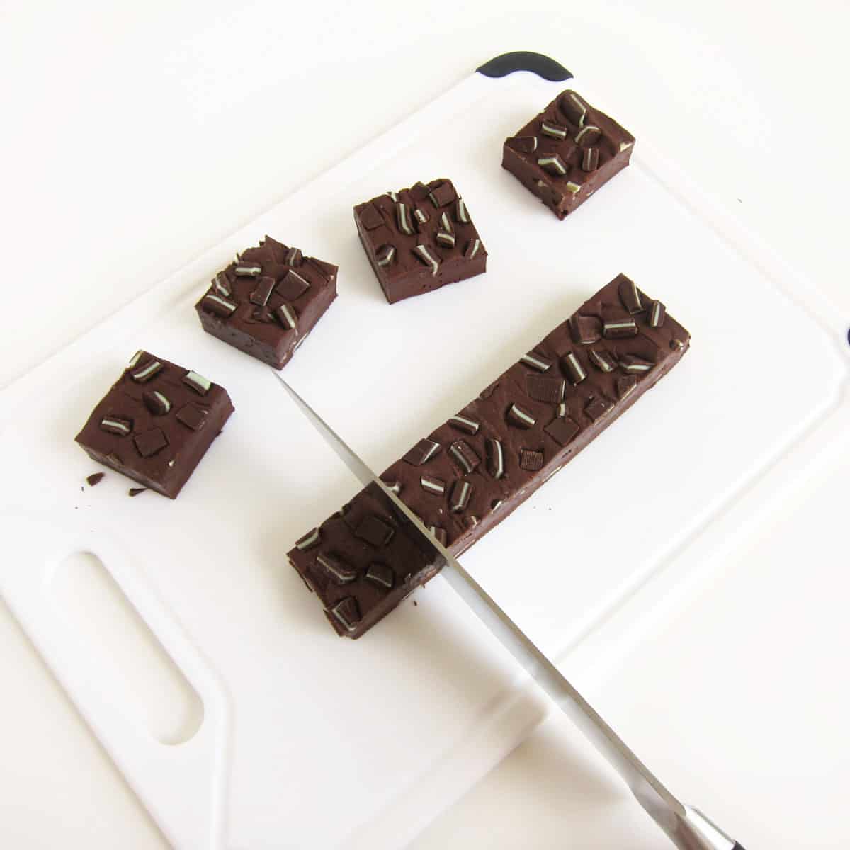 cutting chocolate Andes Mint fudge into squares
