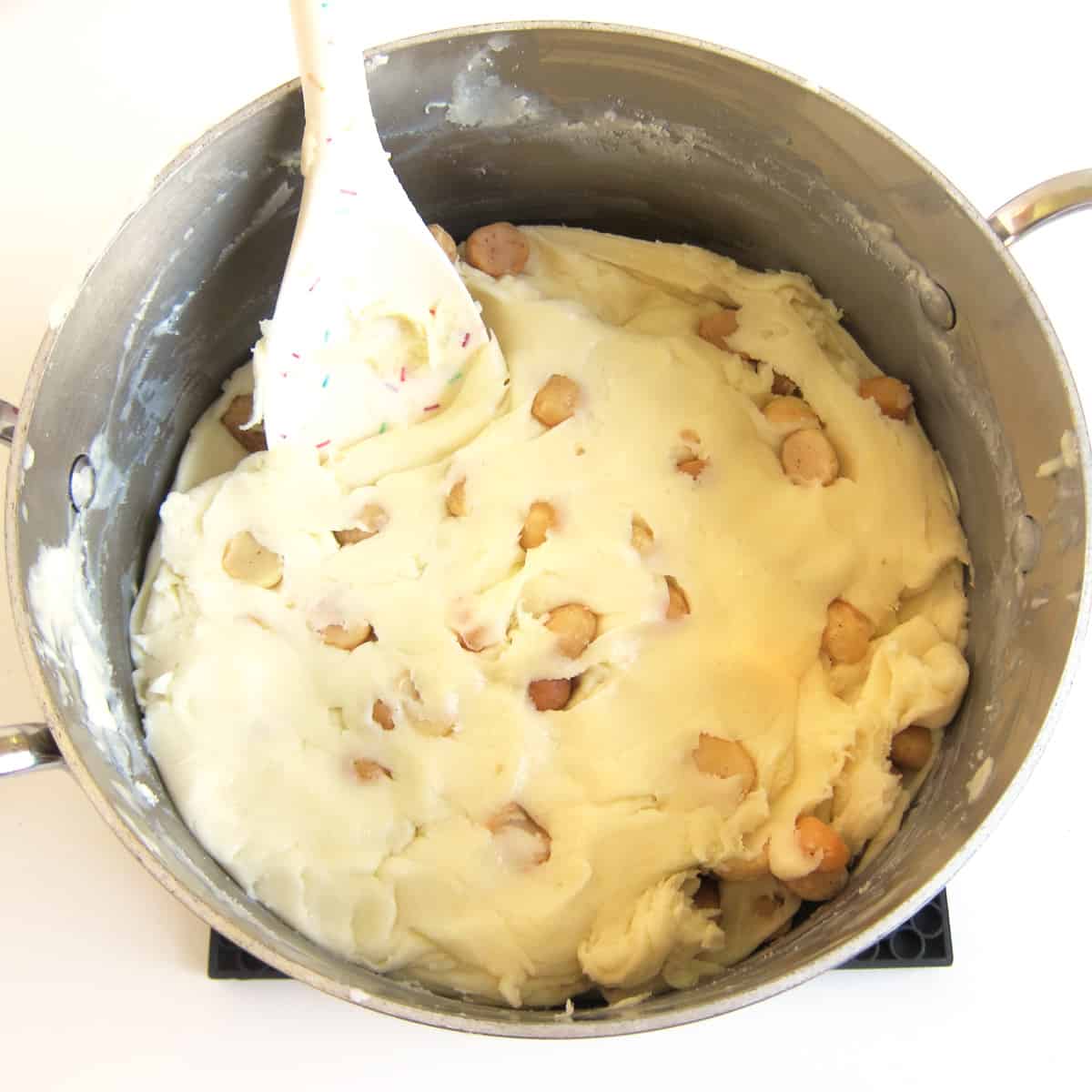 Macadamia nut fudge mixed in saucepan.