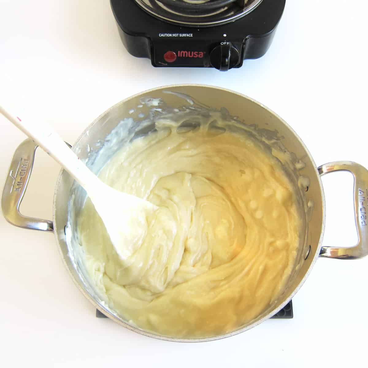 Melted white chocolate and sweetened condensed milk stirred together in a medium saucepan off heat.